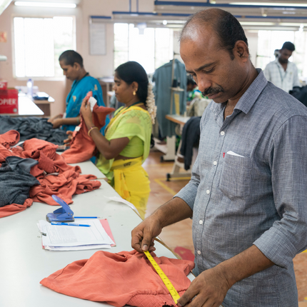 Man Measuring Cloth in Fair Trade Certified Factory